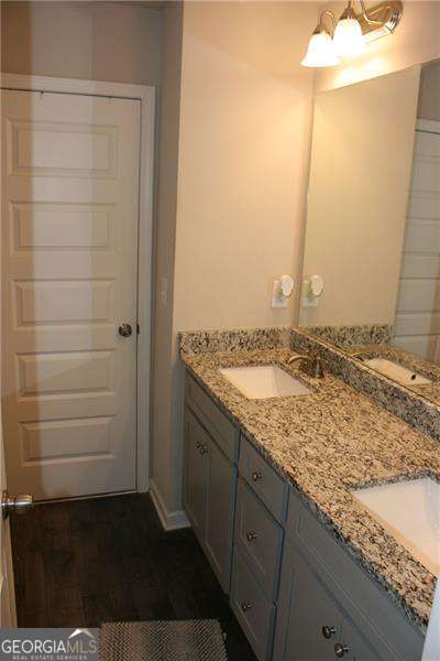 131 Queens Cemetery Rd, Good Hope, GA 30641 - bathroom with double vanity and a chandelier