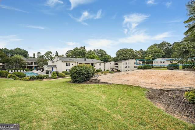 1150 Collier Rd NW Unit 25D, Atlanta, GA 30318 - view of green lawn featuring volleyball court, a residential view, and an outdoor pool