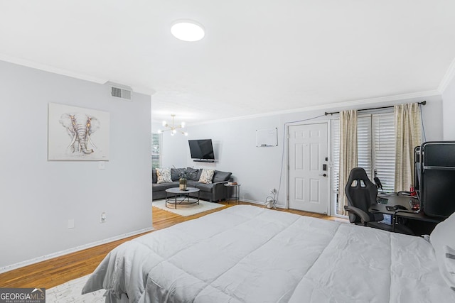 1150 Collier Rd NW Unit 25D, Atlanta, GA 30318 - bedroom with crown molding, wood finished floors, a chandelier, baseboards, and an office area