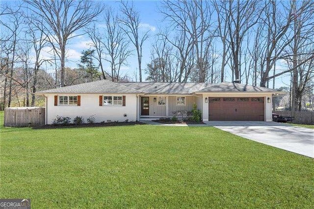 ranch-style home featuring an attached garage and driveway