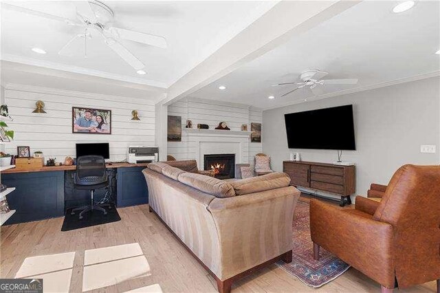 living area featuring ceiling fan, light wood finished floors, a fireplace, recessed lighting, and a desk