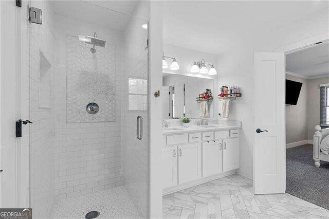 full bathroom with a shower stall, double vanity, and ornamental molding