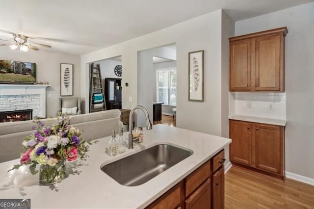 143 Treadstone Ln, Dallas, GA 30132 - kitchen with open floor plan, light wood finished floors, light countertops, brown cabinets, and ceiling fan