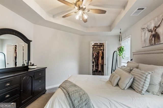 143 Treadstone Ln, Dallas, GA 30132 - bedroom featuring a raised ceiling, a spacious closet, dark carpet, a closet, and ceiling fan