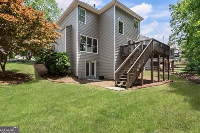143 Treadstone Ln, Dallas, GA 30132 - rear view of house featuring a wooden deck, stairway, and a yard