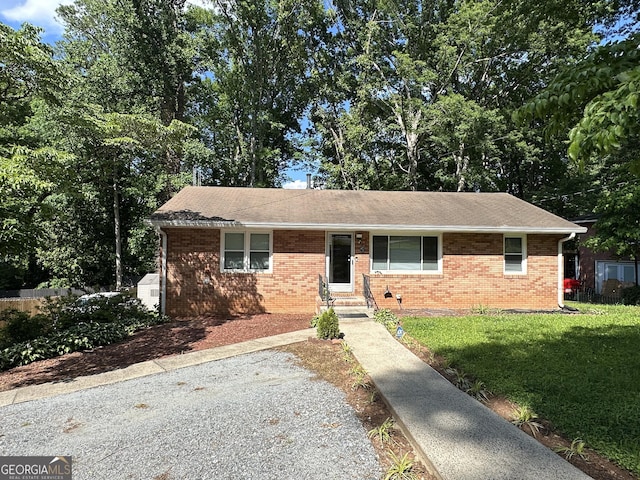 2059 Clearwater Dr SE, Marietta, GA 30067 - ranch-style home with brick siding, a front yard, entry steps, and a shingled roof