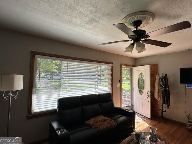 2059 Clearwater Dr SE, Marietta, GA 30067 - living room with a textured ceiling, wood finished floors, ceiling fan, and baseboards