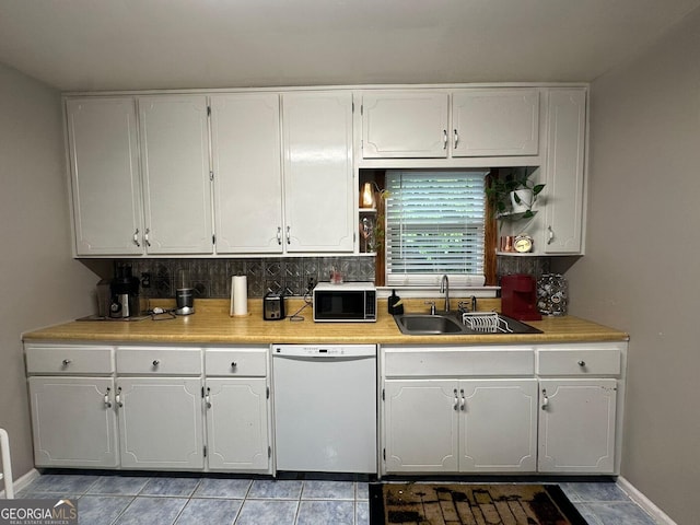 2059 Clearwater Dr SE, Marietta, GA 30067 - kitchen featuring white dishwasher, a sink, white cabinets, tasteful backsplash, and light countertops