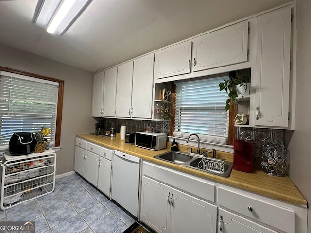 2059 Clearwater Dr SE, Marietta, GA 30067 - kitchen with a sink, white dishwasher, white cabinetry, and tasteful backsplash