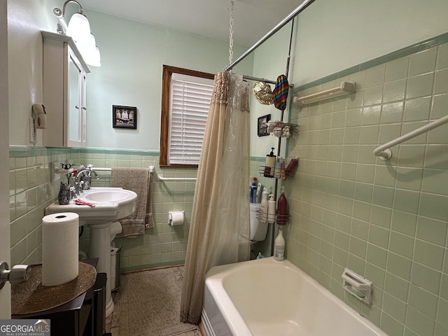 2059 Clearwater Dr SE, Marietta, GA 30067 - bathroom with tile walls, shower / tub combo with curtain, a wainscoted wall, and a sink