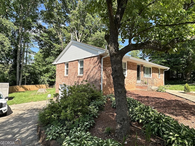 2059 Clearwater Dr SE, Marietta, GA 30067 - view of front of home with brick siding, fence, and concrete driveway