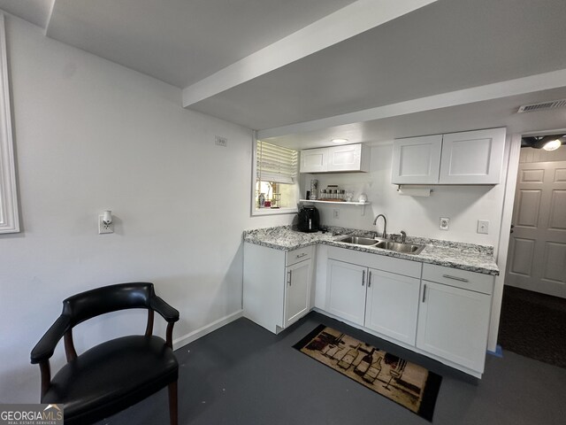 2059 Clearwater Dr SE, Marietta, GA 30067 - kitchen featuring a sink, white cabinetry, baseboards, light stone countertops, and open shelves