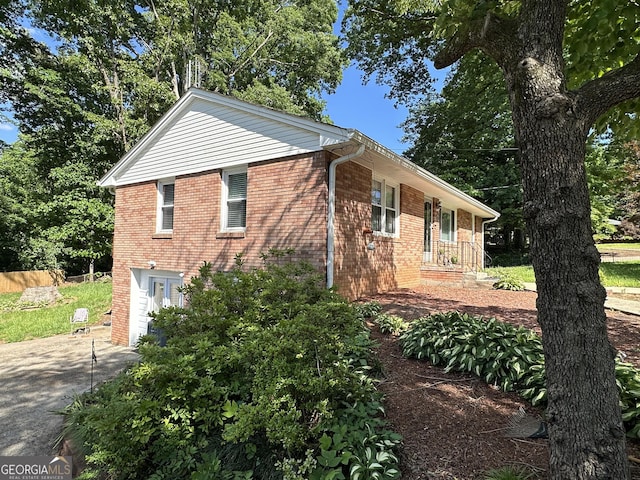 2059 Clearwater Dr SE, Marietta, GA 30067 - view of side of property featuring brick siding, driveway, and a garage