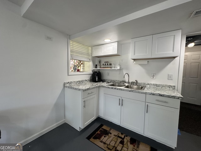 2059 Clearwater Dr SE, Marietta, GA 30067 - kitchen with a sink, white cabinetry, open shelves, light stone countertops, and baseboards