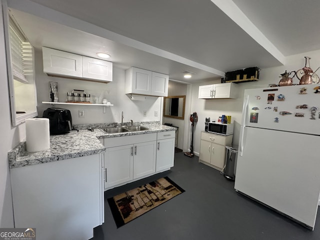 2059 Clearwater Dr SE, Marietta, GA 30067 - kitchen with freestanding refrigerator, a sink, concrete flooring, white cabinetry, and light countertops