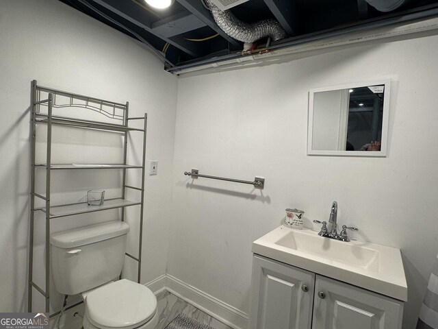 2059 Clearwater Dr SE, Marietta, GA 30067 - bathroom featuring marble finish flooring, toilet, vanity, and baseboards