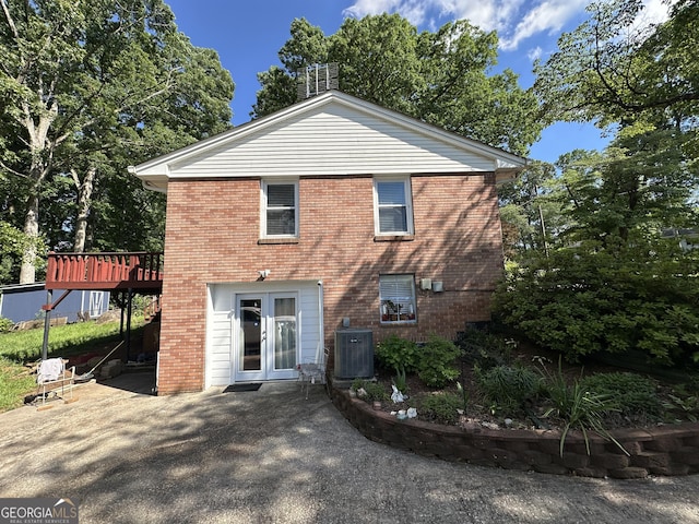 2059 Clearwater Dr SE, Marietta, GA 30067 - rear view of house with french doors, central AC unit, a wooden deck, and brick siding
