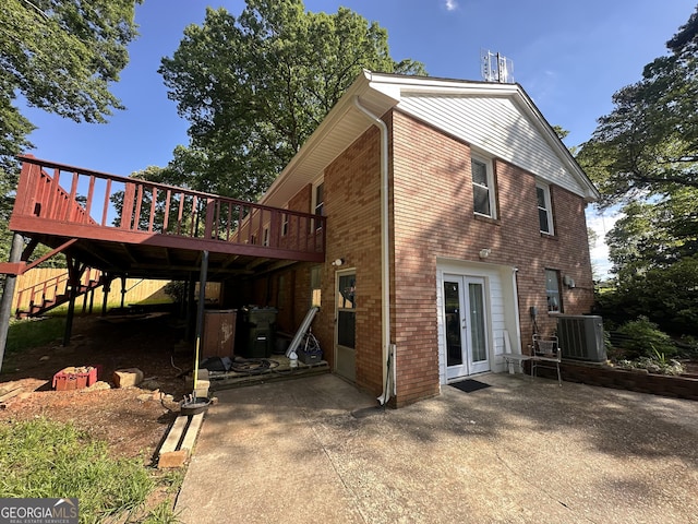 2059 Clearwater Dr SE, Marietta, GA 30067 - rear view of property featuring central air condition unit, a patio area, a deck, stairway, and brick siding