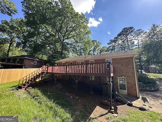 2059 Clearwater Dr SE, Marietta, GA 30067 - rear view of property featuring a wooden deck, stairway, fence, and brick siding