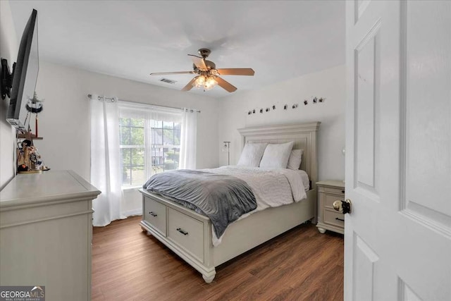 3477 Seneca Farm Dr, Buford, GA 30519 - bedroom with dark wood finished floors and ceiling fan