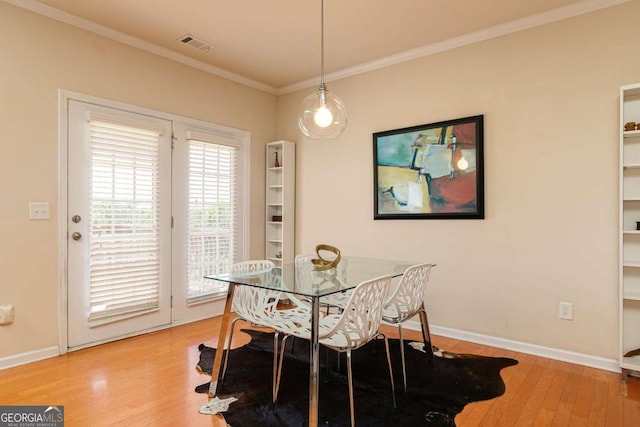 5888 Cobblestone Creek Cir, Mableton, GA 30126 - dining room with crown molding, wood finished floors, and baseboards