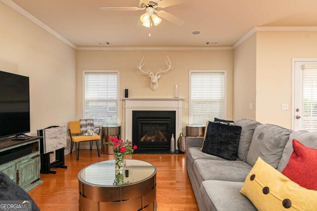 5888 Cobblestone Creek Cir, Mableton, GA 30126 - living area featuring light wood-style floors, healthy amount of natural light, a ceiling fan, and crown molding