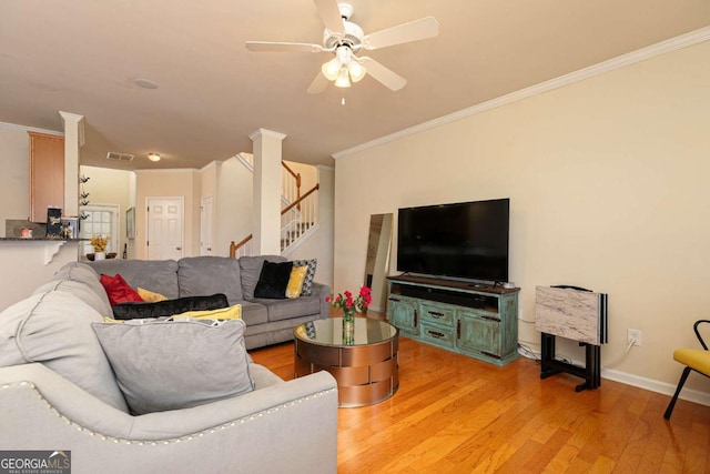 5888 Cobblestone Creek Cir, Mableton, GA 30126 - living room with ornamental molding, a ceiling fan, stairs, light wood-type flooring, and baseboards