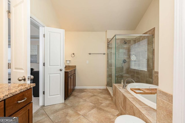 5888 Cobblestone Creek Cir, Mableton, GA 30126 - full bathroom with vanity, vaulted ceiling, a shower stall, a garden tub, and tile patterned floors