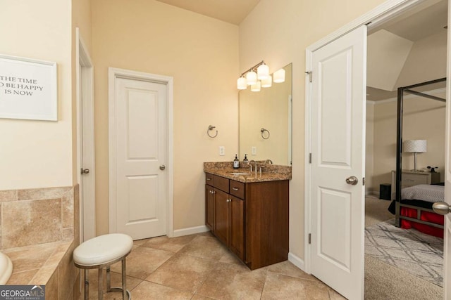 5888 Cobblestone Creek Cir, Mableton, GA 30126 - bathroom featuring vanity, baseboards, tile patterned floors, and a tub to relax in