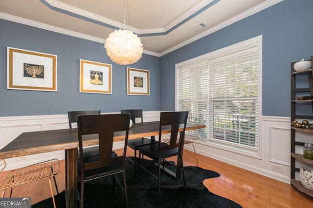 5888 Cobblestone Creek Cir, Mableton, GA 30126 - dining room featuring wood finished floors, a chandelier, wainscoting, ornamental molding, and a decorative wall