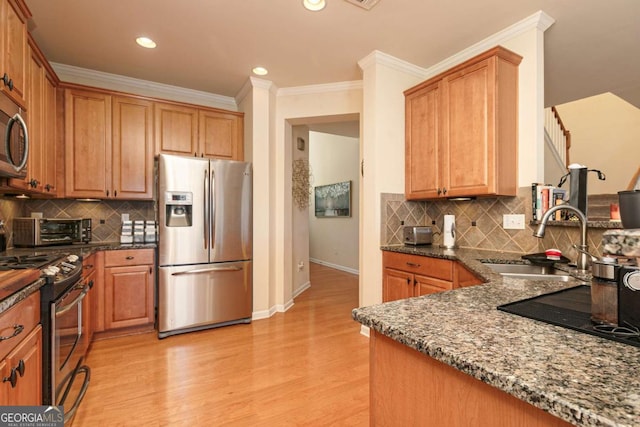 5888 Cobblestone Creek Cir, Mableton, GA 30126 - kitchen featuring appliances with stainless steel finishes, a sink, light wood-type flooring, ornamental molding, and dark stone countertops