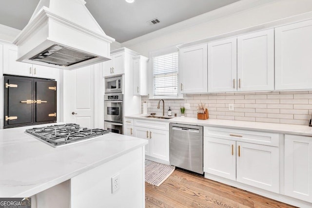 5461 Autumn Flame Dr, Braselton, GA 30517 - kitchen featuring stainless steel appliances, a sink, premium range hood, and white cabinets