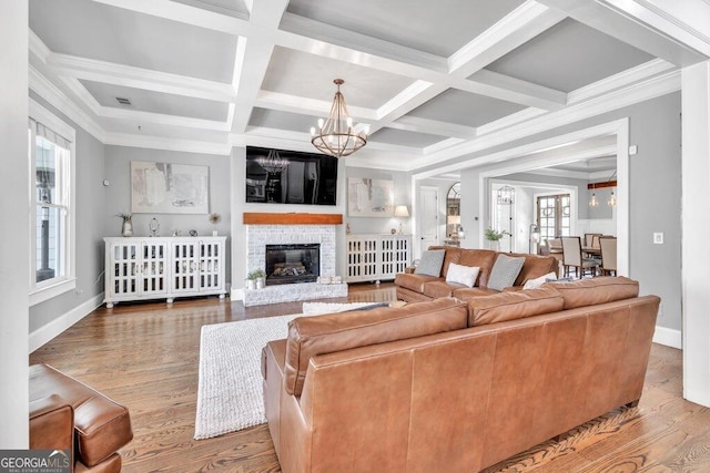 5461 Autumn Flame Dr, Braselton, GA 30517 - living area with healthy amount of natural light, a chandelier, coffered ceiling, beam ceiling, and wood finished floors