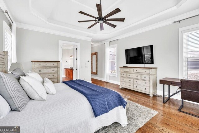 5461 Autumn Flame Dr, Braselton, GA 30517 - bedroom featuring a raised ceiling, multiple windows, wood finished floors, crown molding, and baseboards