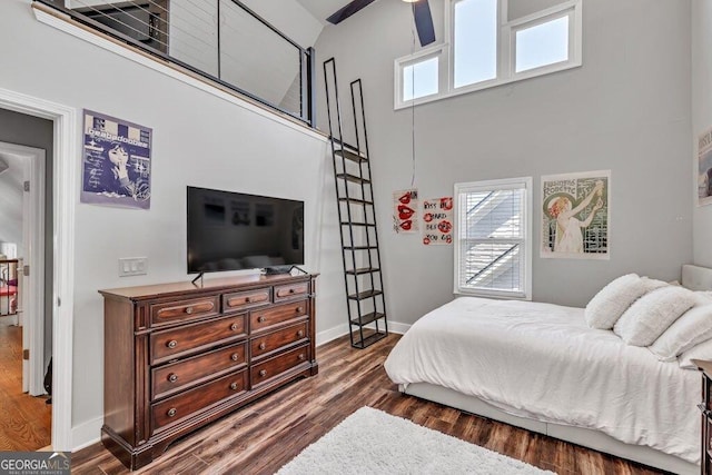 5461 Autumn Flame Dr, Braselton, GA 30517 - bedroom featuring a towering ceiling, dark wood-style flooring, and baseboards