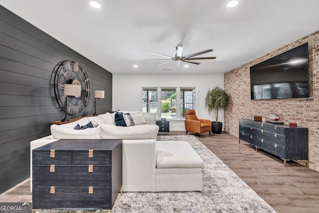 5461 Autumn Flame Dr, Braselton, GA 30517 - living room featuring a ceiling fan, recessed lighting, wood finished floors, brick wall, and wooden walls