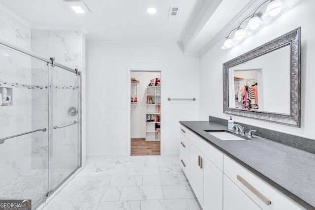 5461 Autumn Flame Dr, Braselton, GA 30517 - full bathroom with marble look tiles, ornamental molding, vanity, a walk in closet, and a stall shower