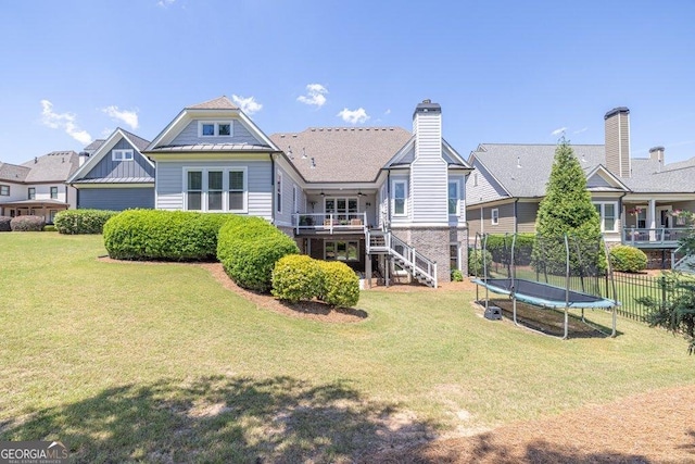 5461 Autumn Flame Dr, Braselton, GA 30517 - back of house featuring stairs, a trampoline, and a standing seam roof