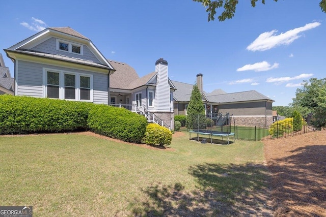 5461 Autumn Flame Dr, Braselton, GA 30517 - back of property featuring a trampoline