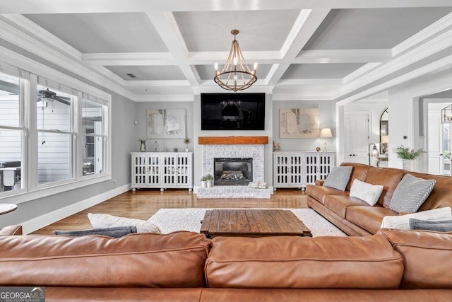 5461 Autumn Flame Dr, Braselton, GA 30517 - living area featuring a chandelier, plenty of natural light, baseboards, a glass covered fireplace, and coffered ceiling
