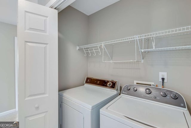 laundry area featuring washing machine and clothes dryer