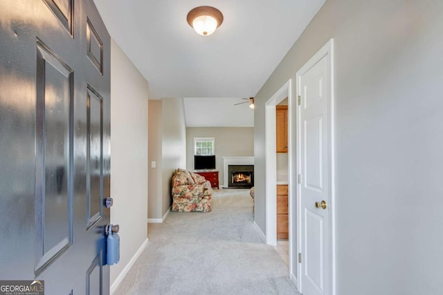 corridor with light carpet and baseboards
