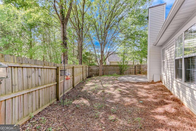 fenced backyard with a patio area