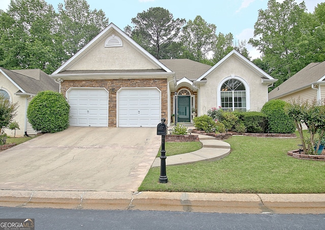 323 Newfield Way, Peachtree City, GA 30269 - view of front of house with an attached garage, driveway, a front yard, and stucco siding