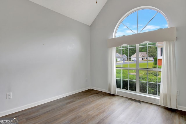 323 Newfield Way, Peachtree City, GA 30269 - spare room with wood finished floors, vaulted ceiling, and baseboards