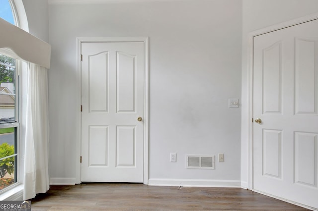 323 Newfield Way, Peachtree City, GA 30269 - unfurnished bedroom featuring wood finished floors and baseboards