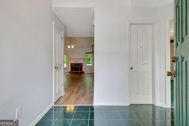 323 Newfield Way, Peachtree City, GA 30269 - hall with dark tile patterned floors, baseboards, and a textured ceiling