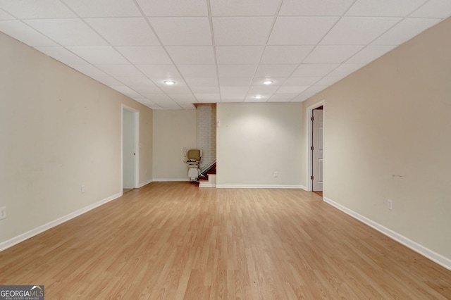 323 Newfield Way, Peachtree City, GA 30269 - unfurnished living room with light wood-style flooring, baseboards, recessed lighting, and a paneled ceiling