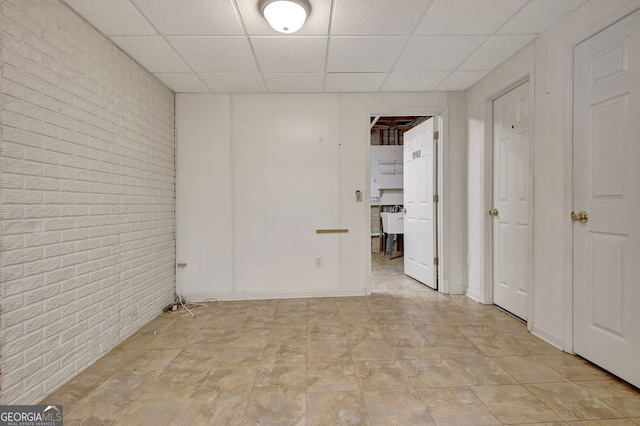 323 Newfield Way, Peachtree City, GA 30269 - unfurnished room featuring brick wall and a drop ceiling