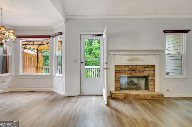 323 Newfield Way, Peachtree City, GA 30269 - doorway with wood finished floors, a chandelier, a glass covered fireplace, and ornamental molding